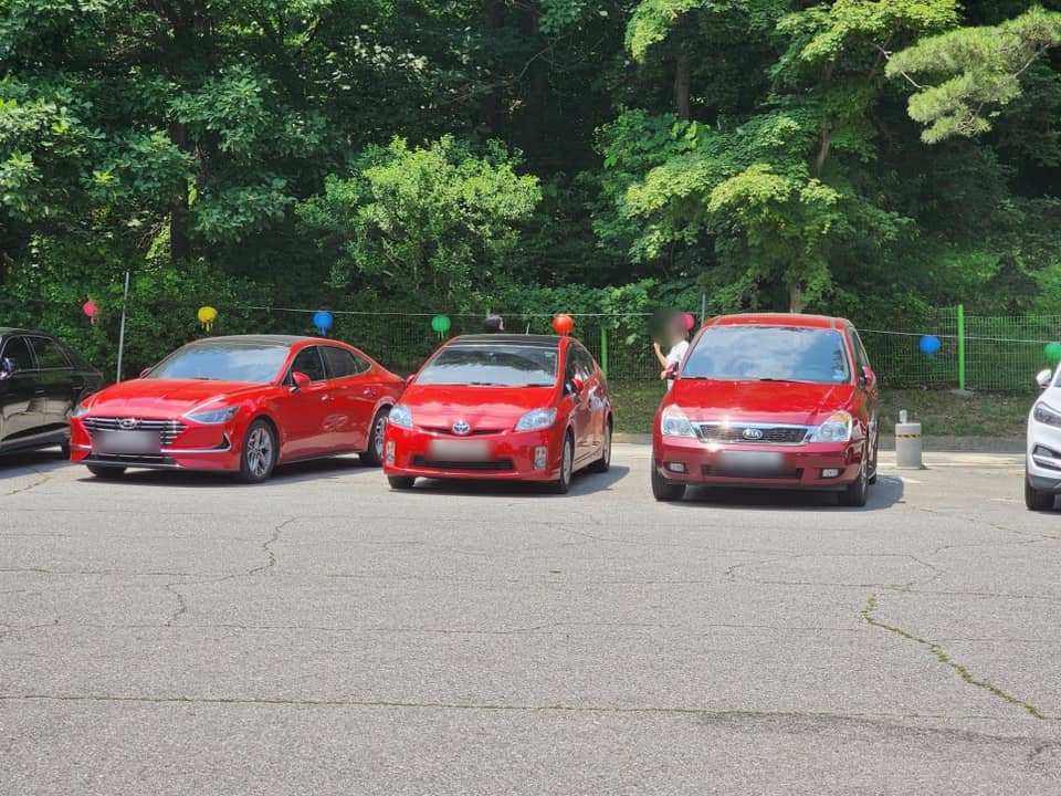 Three red cars in Bongseonsa parking lot